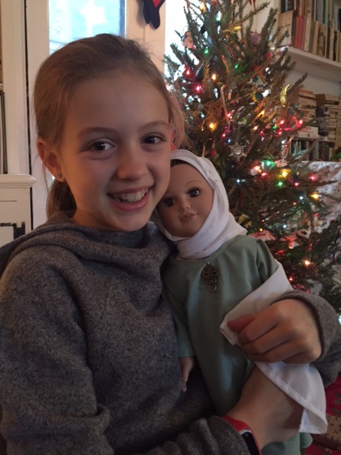 Girl showing her Refugee Doll.